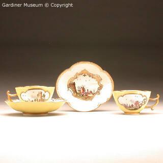 Pair of teacups and saucers with harbour scenes