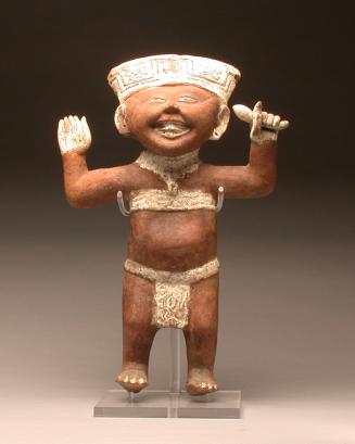 'Smiling face' standing male figure with rattle