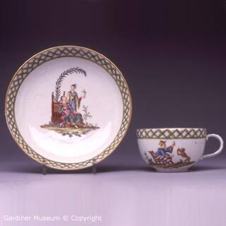 Teacup and saucer painted with chinoiseries