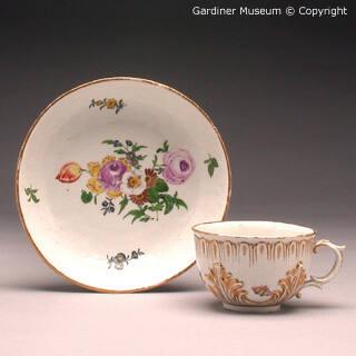 Cup and saucer with flowers and insects