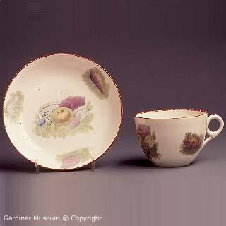 Teacup and saucer with printed shell pattern