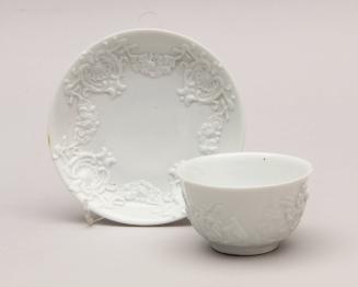 Tea bowl and saucer, relief moulded