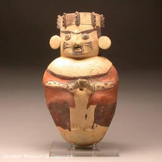 Standing male figure holding a cup