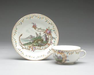 Cup and saucer with churches, houses and a bridge