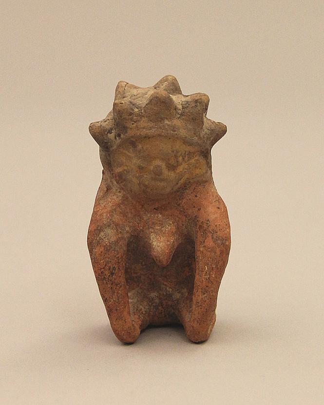 Seated figure with spiked headdress