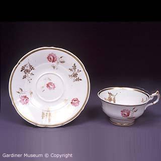 Teacup and saucer with rose pattern