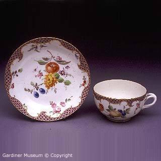 Teacup and saucer with Giles-style purple-scale pattern
