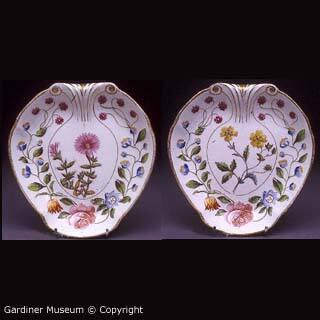 Pair of shell-shaped moulded dishes with named botanicals