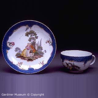 Teacup and saucer with Watteauesque figures