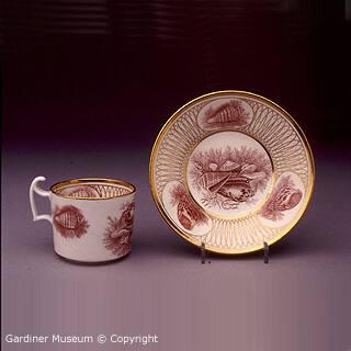 Coffee can and saucer with printed reserves and geometric bands