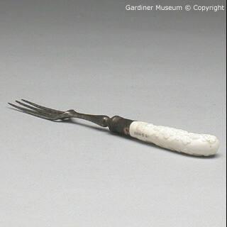 Fork handle with moulded prunus motif